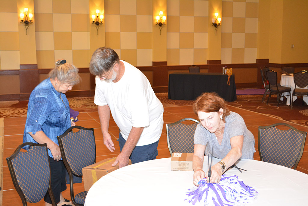 Kathy and Ron Kohl plus Kathy Norris setting up table decorations